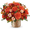 Orange roses and red mums in a woven basket