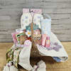 Gift basket with slippers, tumbler, bath items, and a scarf