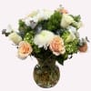 Bouquet of peach and white flowers in a glass vase