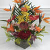 Exotic tall tropical arrangement in a wooden vase
