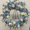 Very large wreath of hydrangeas, roses and greenery. Colors are Light blue