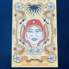 Illustrated book cover with a stylized face and floral motifs