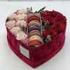 Heart-shaped box with red and white roses and macarons