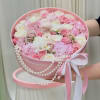 A luxurious floral hatbox designed in soft blush and ivory tones, featuring