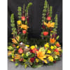 Large floral arrangement with lilies, roses, and tall green spikes