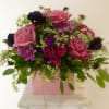 Beautiful assortment of fresh blooms beautifully designed in a cube.