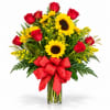 Bouquet of red roses and yellow sunflowers in a clear glass vase with a red bow