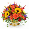 Bright mixed bouquet in a sunflower teacup vase with a matching saucer