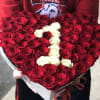 Heart-shaped bouquet of red and white roses in a gift box