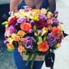 Mixed bouquet of roses, orchids, and calla lilies in a wooden box