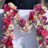 Floral letter arrangement with pink and white roses and orchids