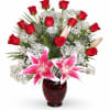 Red roses and pink lilies arranged in a dark red vase