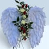 Floral angel wings with red and white roses on a stand