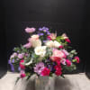 Mixed pink, white, and purple bouquet in a patterned glass vase
