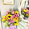 Colorful mixed bouquet in a lavender hat box with a ribbon