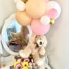 Teddy bear with pastel balloons and a flower box arrangement