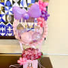 Birthday balloon display with pink roses in a gift box