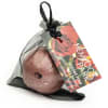 Wrapped bath bomb in a black mesh pouch with a rose-themed tag
