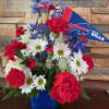 Bouquet of red, white, and blue flowers with a Buffalo Bills pennant