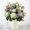 Lavender and white bouquet in a cream vase