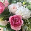 Pink and white roses with white chrysanthemum blooms in a bouquet