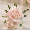 Single pink rose with pink and white fillers. 