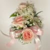 Pink roses and white orchids with baby's breath and a pink ribbon bow