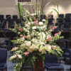 Large white and pink floral arrangement in a tall vase