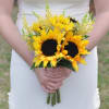 Bride holding a bouquet of yellow sunflowers with airy filler flowers