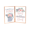 Two floral-themed printed signs with a watering can and "Grandma's Heart" text
