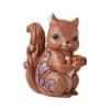 Decorative squirrel figurine holding an apple