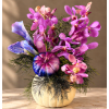 Purple and pink orchids arranged in a cream pumpkin vase