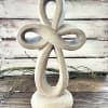Stone knot sculpture on a wooden surface