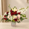 Mixed bouquet of red and white flowers in a heart-decorated vase