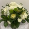 White and green floral arrangement in a glass vase
