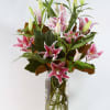 Pink lilies arranged in a clear glass vase