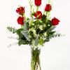 Red roses and white orchids in a clear glass vase