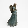Angel figurine with folded hands and leaf-like dress