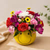 Mixed bouquet in a yellow smiley-face vase