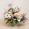 Pink and white flower arrangement in a vase with an "It's a GIRL" sign