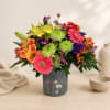 Colorful mixed bouquet in a gray floral tin container