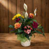 Mixed flower arrangement in a white basket with roses, lilies, and daisies
