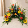 Colorful floral spray with sunflowers and orange roses on a table