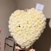 Heart-shaped bouquet of cream white roses on an easel