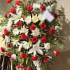Large red and white funeral spray with roses, lilies, and chrysanthemums