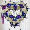 Blue flowers with deep purple roses and white flowers.