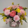 Pink and yellow mixed flower arrangement in a square vase