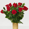 Red roses arranged in a gold vase