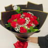 Bouquet of red roses with baby's breath in black wrap and a red ribbon