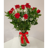 Red roses with baby's breath in a glass vase tied with a red ribbon